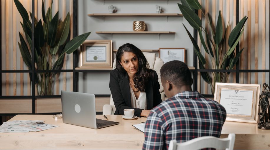 A man talking to a lawyer in her office.